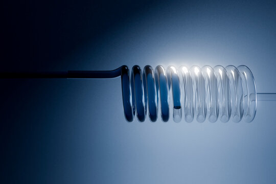  3D render of partial glass coil fading into soft light
