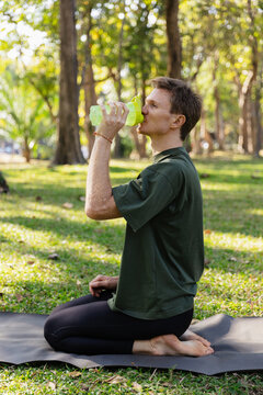 Man drinking water during yoga