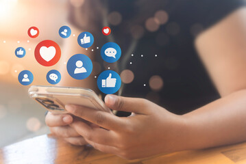 Woman hand hold smartphone and use social media network application to check new feedback or...