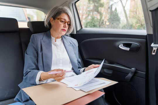 Businesswoman reviewing documents and working 