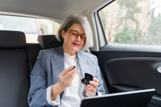 Businesswoman preparing wireless earphones 