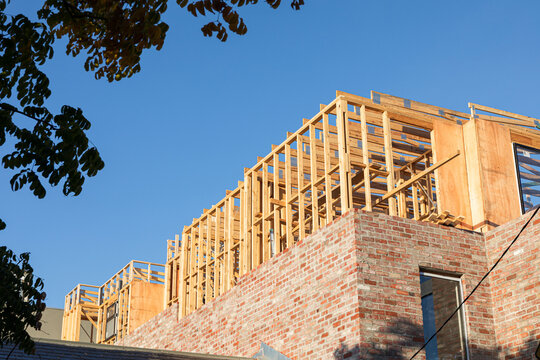 Building construction with wooden frame and bricks.