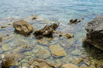 Beautiful rocks and bright turquoise water among layered rocks near Budva, Montenegro. Tropical summer landscape exotic beach on the Adriatic Sea. Vacation holiday idea 