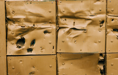 Impact marks and damage on a  metal surface from explosions