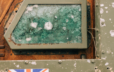 War vehicle showing battle damage with shattered glass 