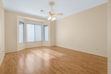 Bright and spacious empty residential rooms featuring natural light, neutral walls, and large windows. Ideal for real estate, interior design, and home staging themes.