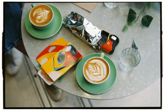 Coffee cups and disposable camera on caffee table