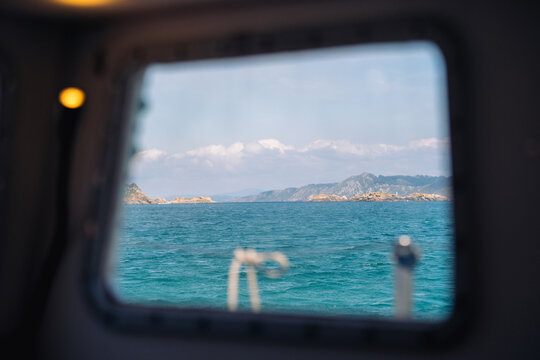 Fototapeta Coastal landscape framed by boat window