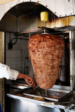 Al pastor meat cooking on a spit