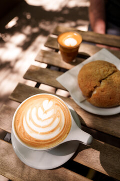 Latte with latte art and a Mexican concha pastry