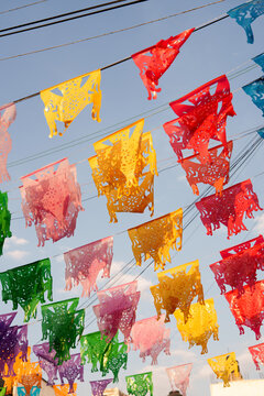 Colorful paper flags hang over an outdoor market