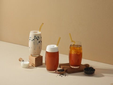 Three glasses of bubble tea with milk, tea, and toppings