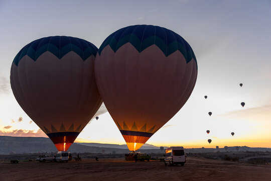 Fototapeta Two hot air balloons rising at dawn