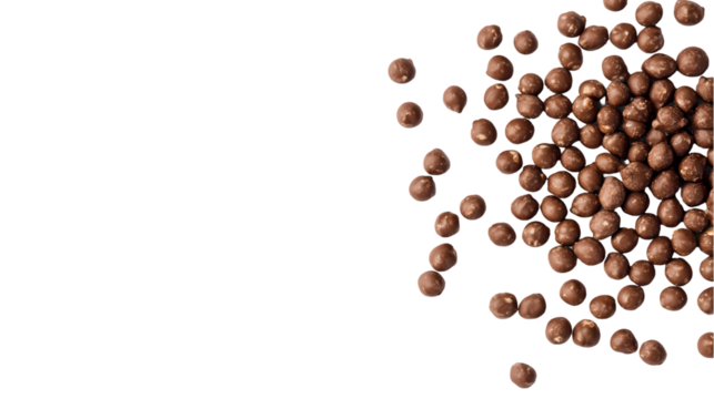 A top down view of a pile of chocolate covered hazelnuts in a shot isolated on transparent background