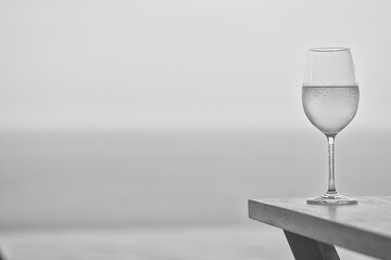 Wine glass close-up in real life, beautiful blurred background of the drink in the glass
