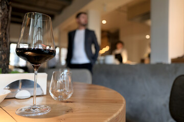 dinner in a restaurant with wine, beautiful table setting, a glass of wine in the foreground