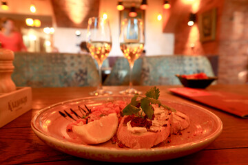 a glass of cold white wine and serving in the restaurant