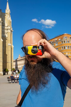 Man Posing with disposable Film Camera