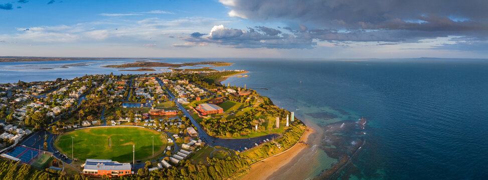 Coastal town on golden light under dramatic sky