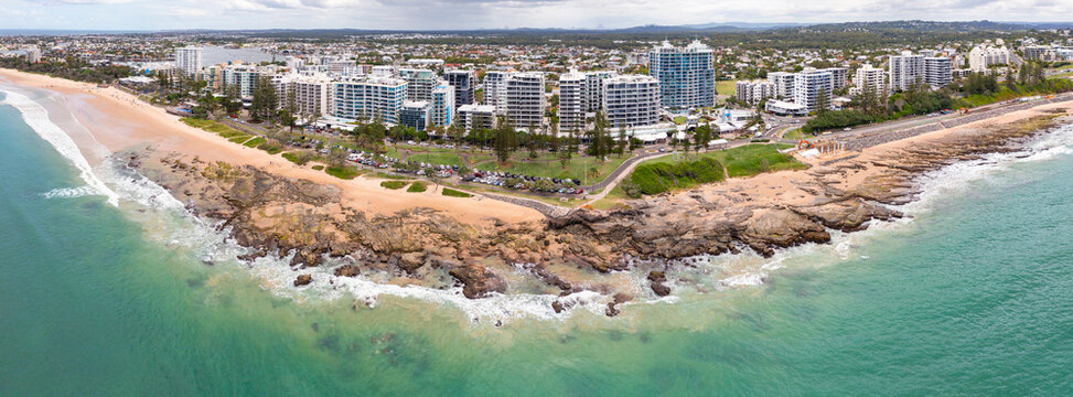High rise waterfront buildings along a rocky coastline