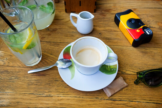 Flat lay of drinks and camera on table