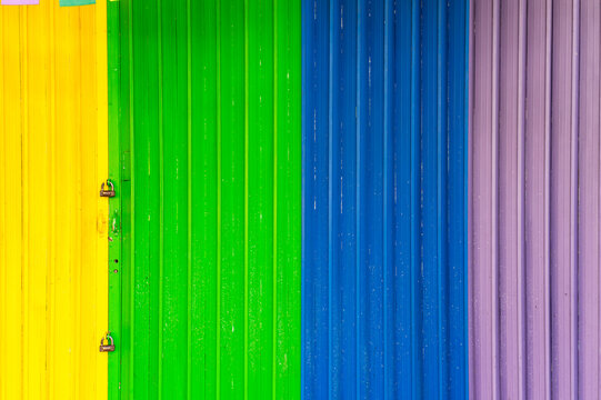 Colorful rainbow Pride flag in metal door