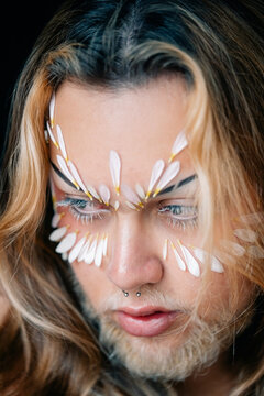 Detailed view of person&rsquo;s decorated eyes and brow with petal makeup