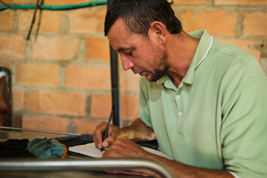 Farmer taking notes on milk production and storage process