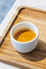 Freshly brewed espresso served in a small cup on a table