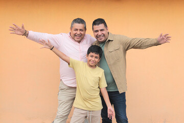 Three generations of a dark-skinned Latino grandfather, father, and son show their love and spend time together to celebrate Father's Day