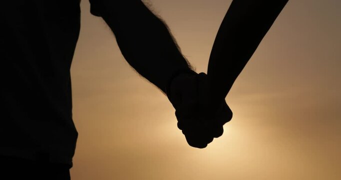 Silhouette father, son shaking hands sunset symbolizes the family heritage and the transmission of wise traditions close up. Emotional connection representing continuity generations values heritage.