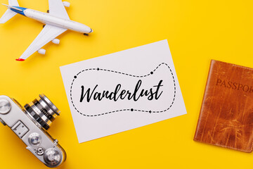 Travel-themed flat lay with blank photo card, camera, toy airplane, and passport