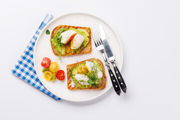 Delicious avocado toasts topped with perfectly cooked poached eggs