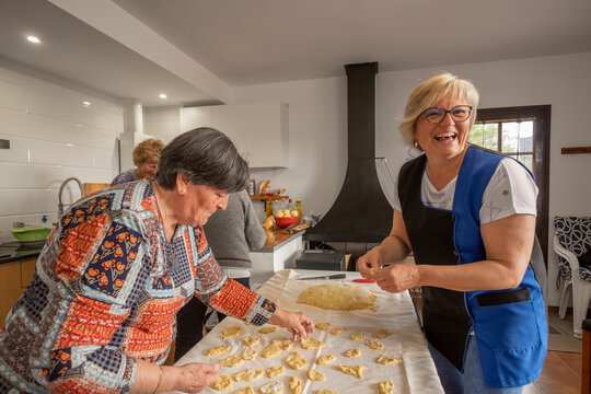 Group of retirees cooking Homemade fritters together