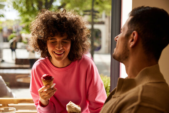 Two people are eating ice cream together