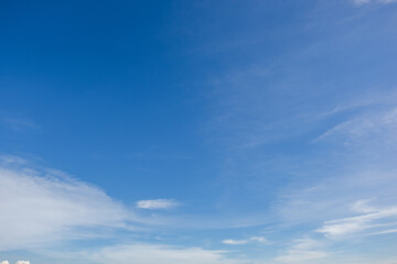 Obraz premium clear blue sky background,clouds with background, Blue sky background with tiny clouds. White fluffy clouds in the blue sky. 