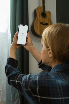 Woman holding smartphone showing loss of internet connection
