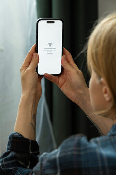 Woman holding smartphone showing internet connection lost message