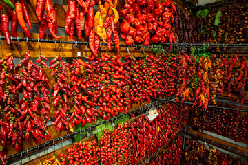 Great view of thousands of threaded chili peppers hanging from a wall at the Mercado dos Lavradores (farmer's market) in Funchal, Madeira, Portugal
