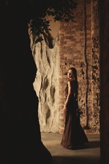 An Ethereal Woman Posed Gracefully in a Dramatic Landscape, embodying elegance and beauty