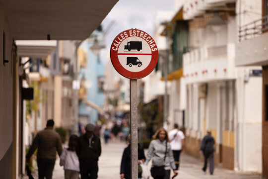 Warning sign on a street with blurred pedestrians