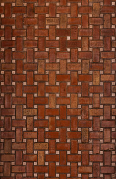 Intricate red brick floor texture with interlocking pattern
