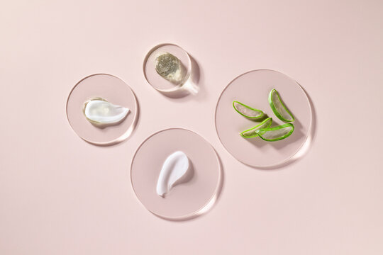 An appealing image showcasing cosmetic creams on pink background.