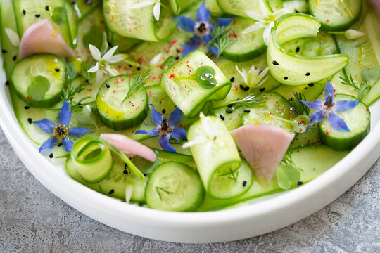 Fresh cucumber salad with spring flowers