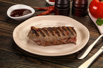 Grilled beef striploin steak with sauce