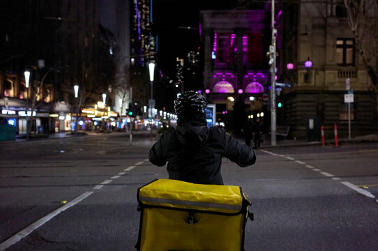 Nighttime Streetscape with food delivery driver