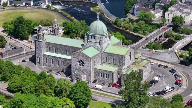 Aerial pull out from Galway Cathedral on Corrib river, West Coast of Ireland. Religious structure.
