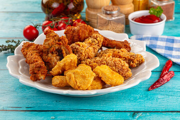 Golden crispy fried chicken mix - wings, drumsticks, nuggets and strips