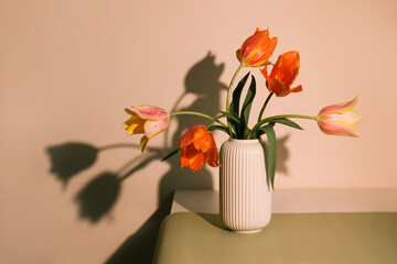 Still life with the bouquet of tulips at the table. 