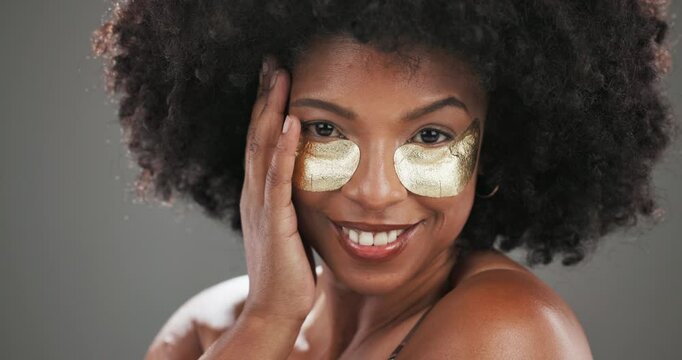 Face, skincare or black woman with beauty, eye patch or cosmetics for glow, application or shine. Depuff, studio or afro girl on grey background with pads, anti aging dermatology product or hydration